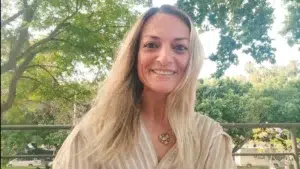 Jenny, una mujer en su nueva versión, en 2025, sonriente, segura y en conexión consigo misma, con los demás y la naturaleza.